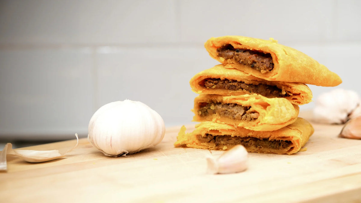 Stack of fresh golden Jamaican vegan patties